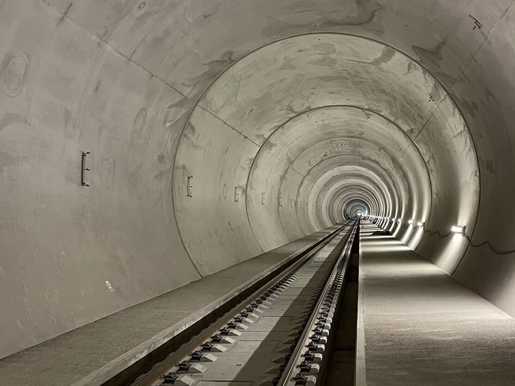 Interior view of the Koralm Tunnel with installed Slab Track Austria and a lateral service walkway.